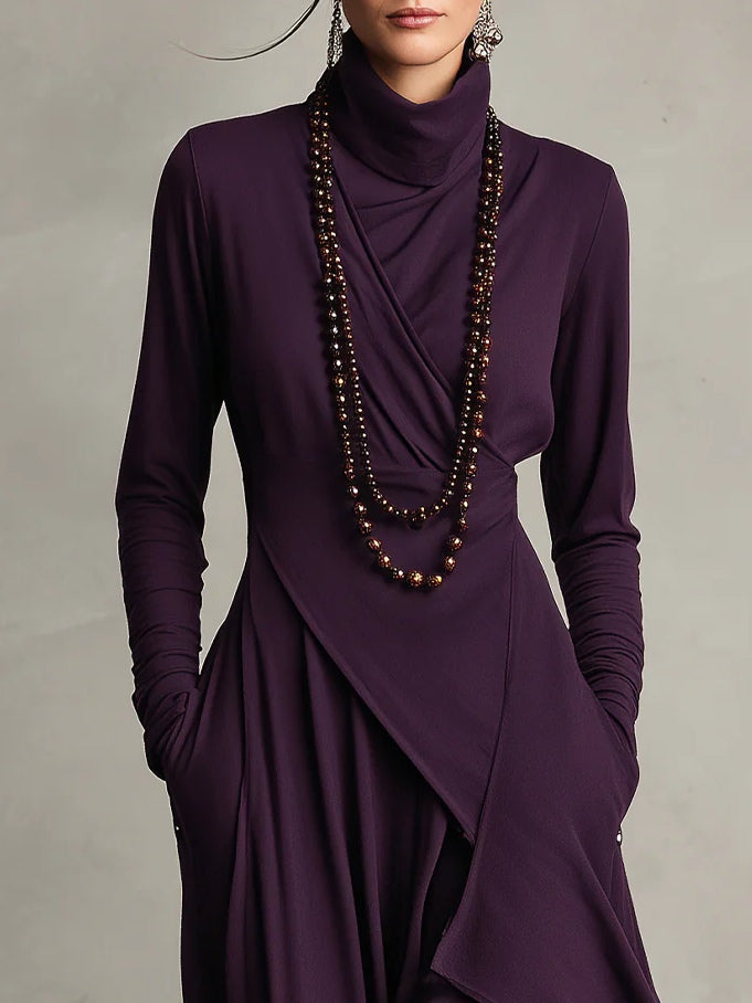 Vestido maxi morado, asimétrico y de cuello alto.